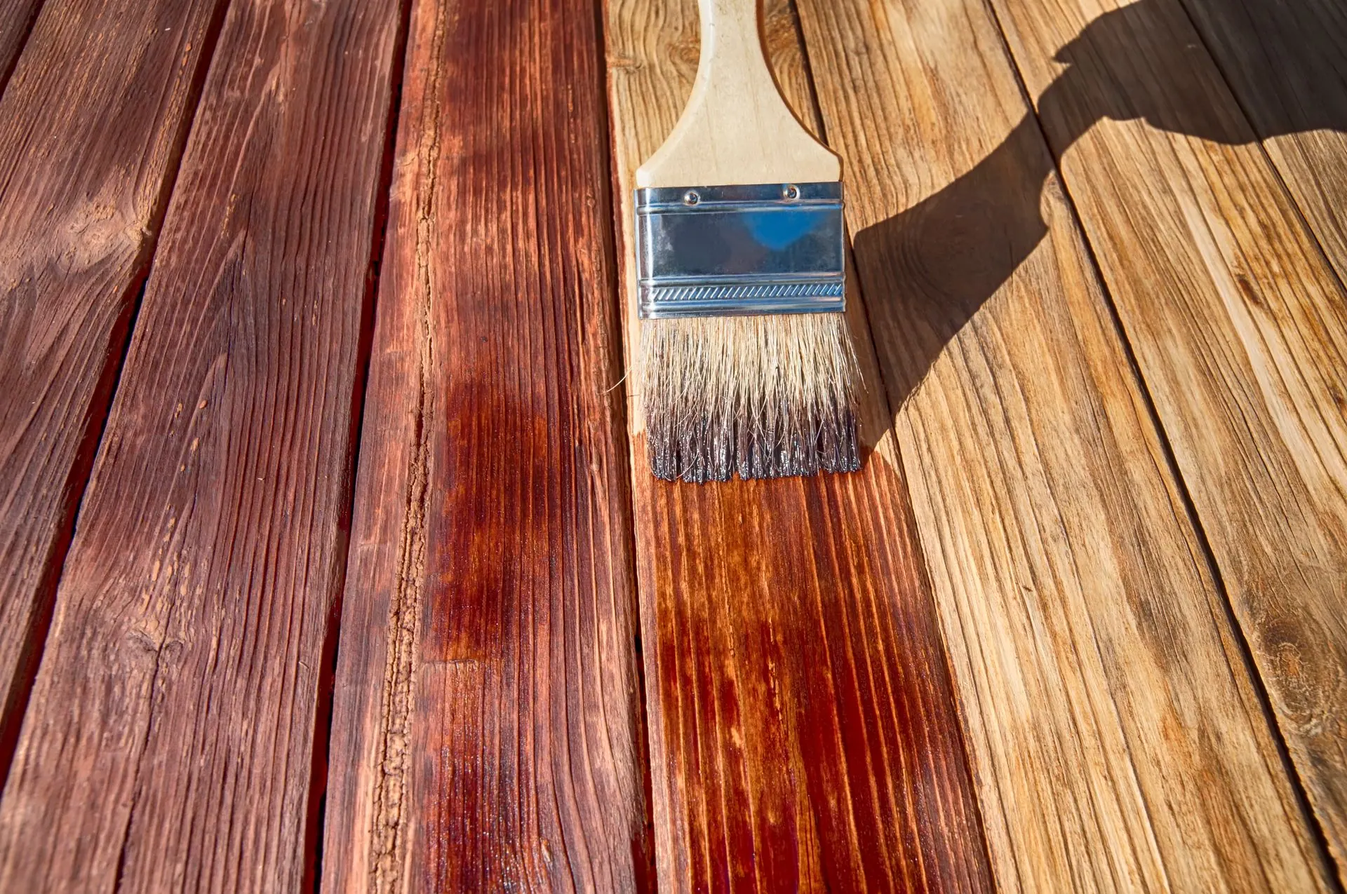 A brush is sitting on top of a wooden table.